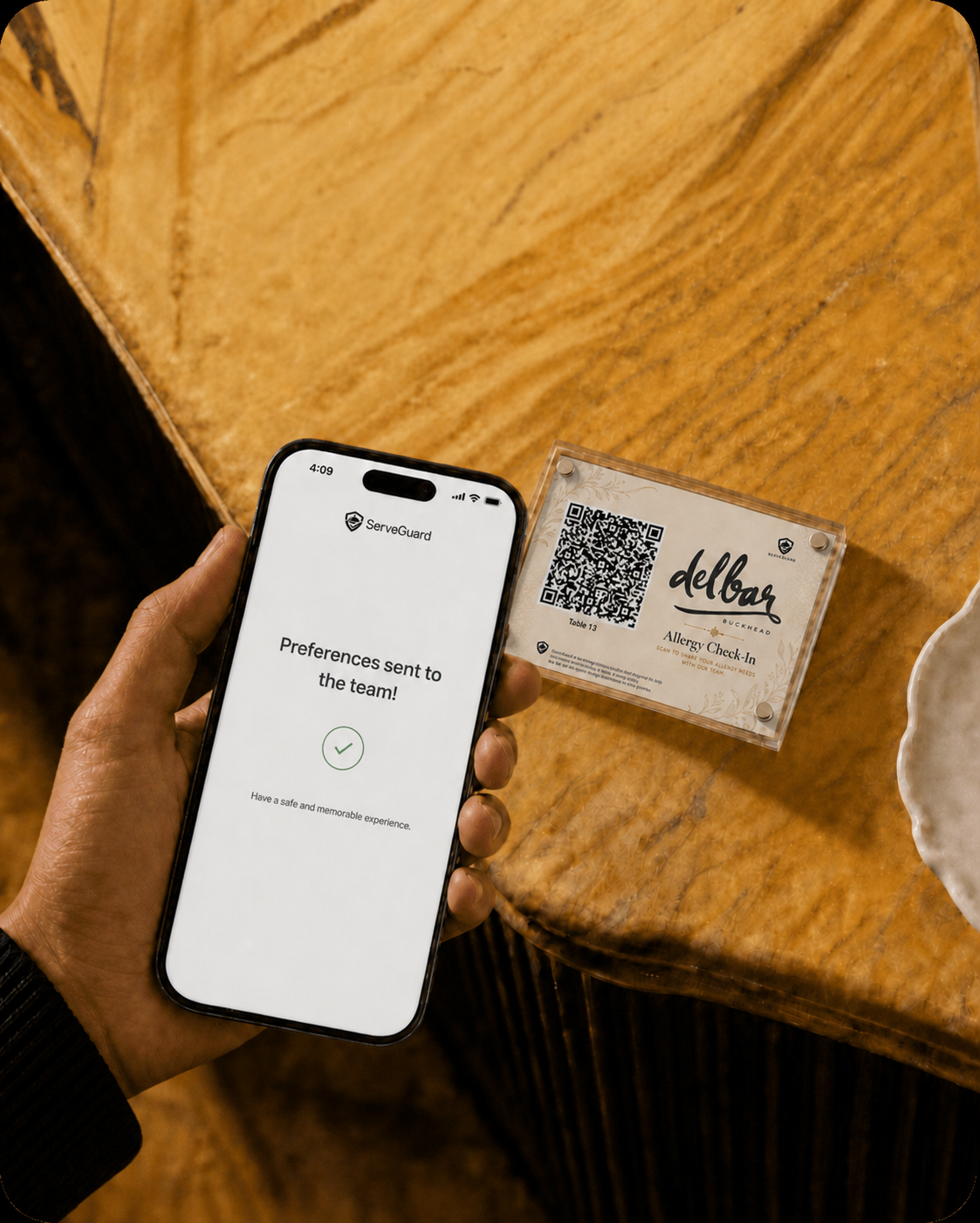 A restaurant guest viewing a discreet ServeGuard confirmation that their allergy preferences were sent to the restaurant team